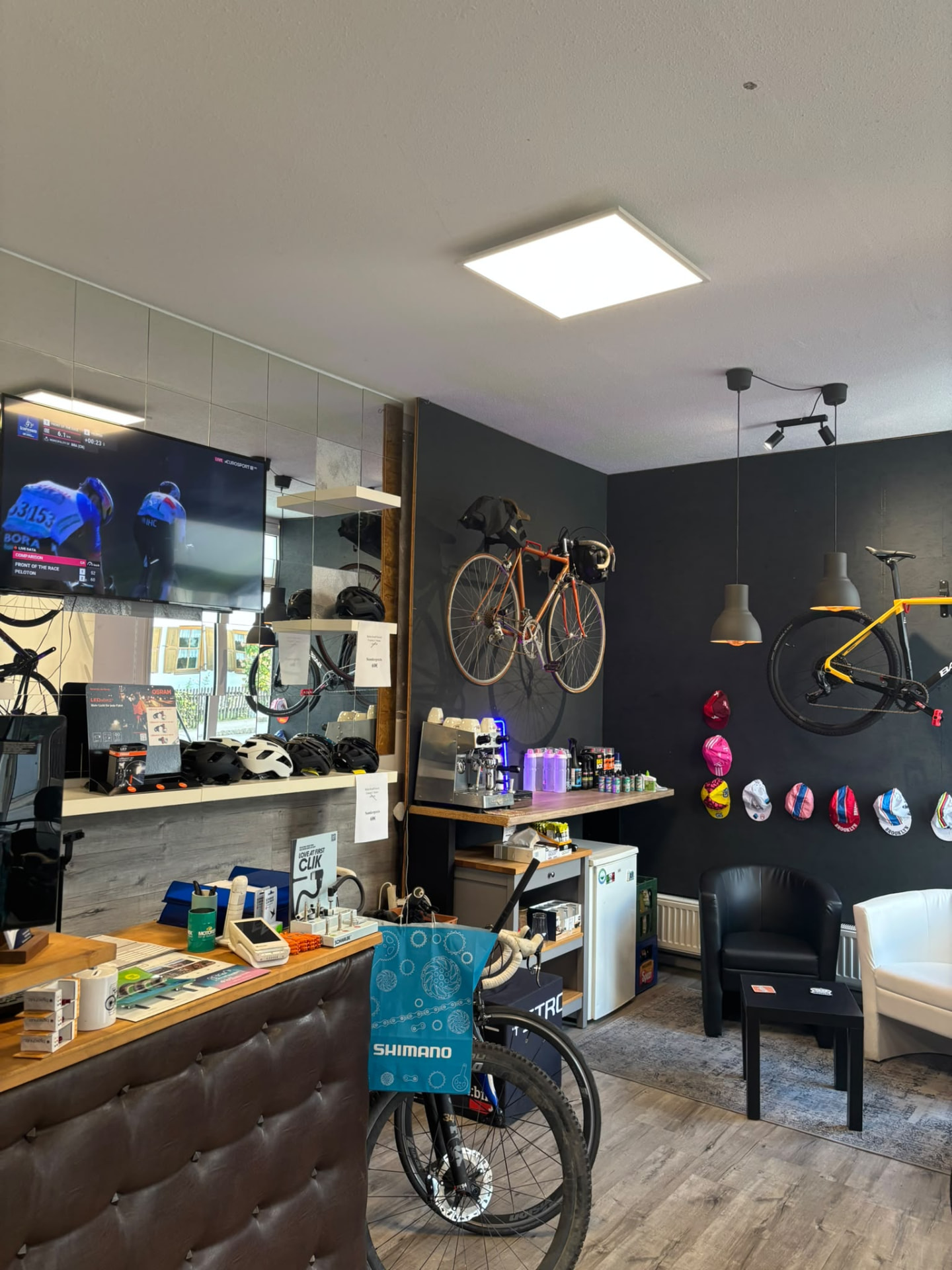 Lounge und Kaffeetheke mit TV und Vintage-Fahrrad bei la Bicicletta